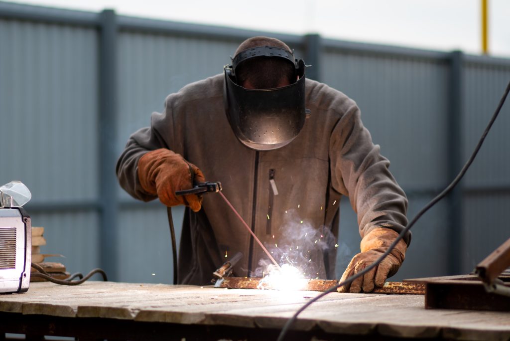 man welding in factory