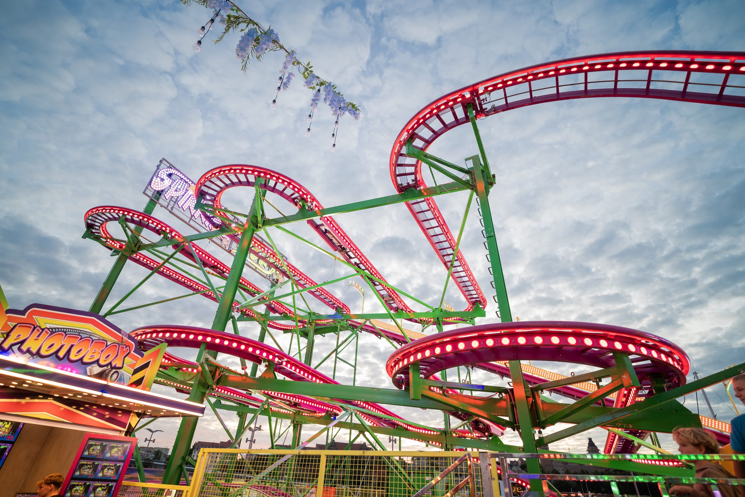 View of Amusement Park roller coaster rides at sunset
