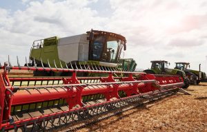 Large combine harvesters parked in agriculturic field at summertime